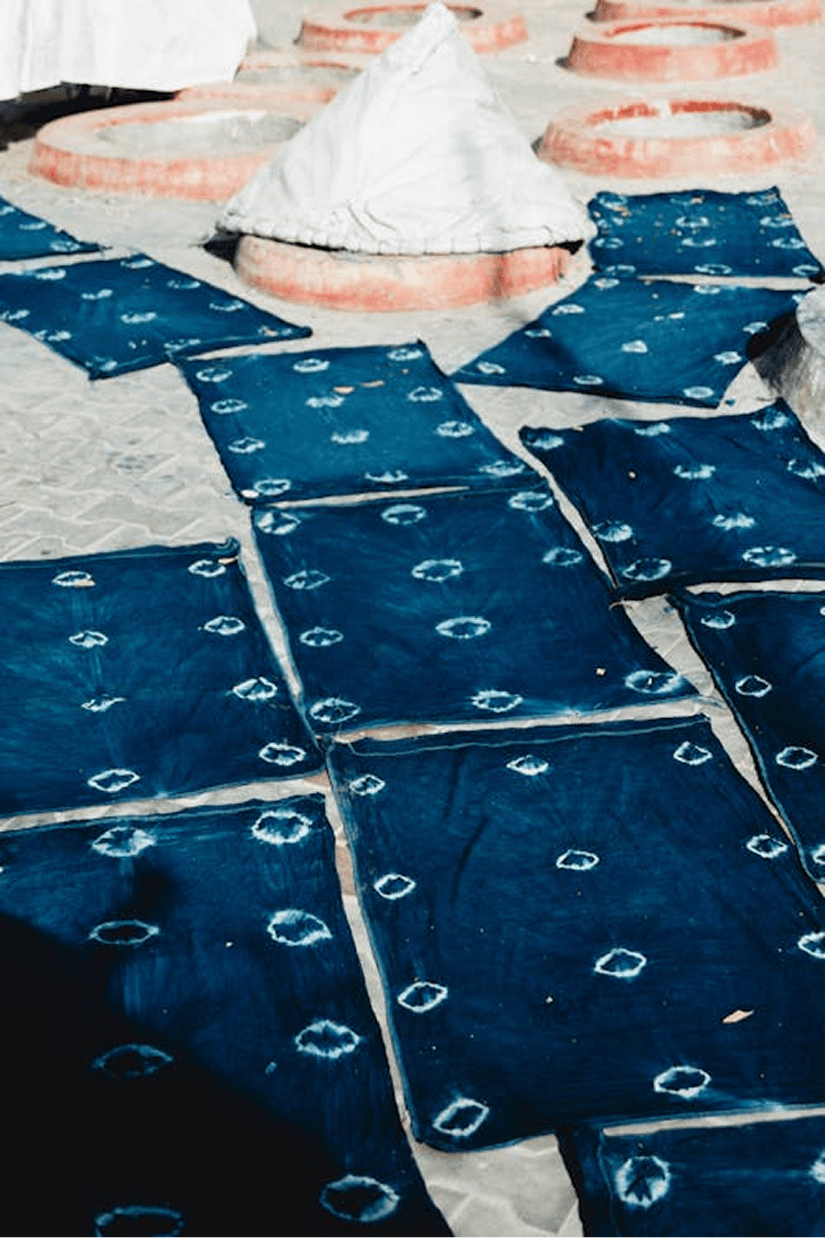 Hand-dyed indigo block-resist panels drying on the floor